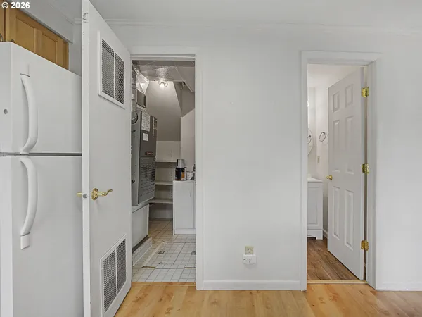a view of a hallway with wooden floor and staircase