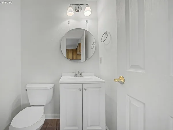 a bathroom with a toilet a sink and mirror