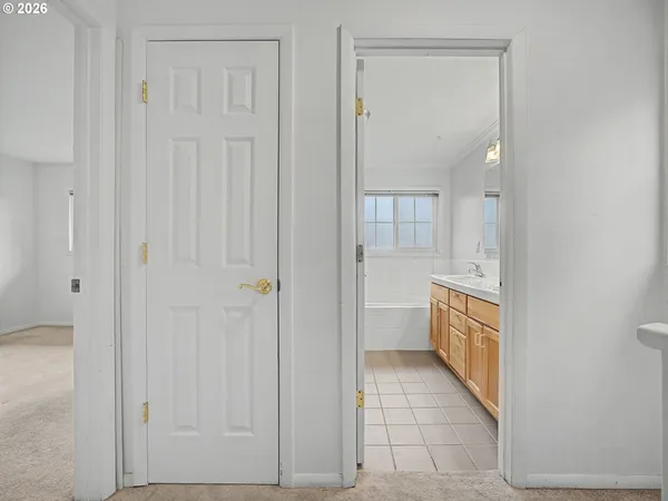 a bathroom with a tub shower and sink