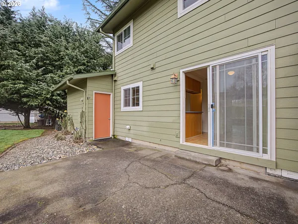 a view of a house with a backyard and trees