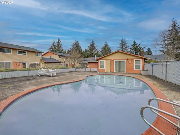 a swimming pool with outdoor seating and yard