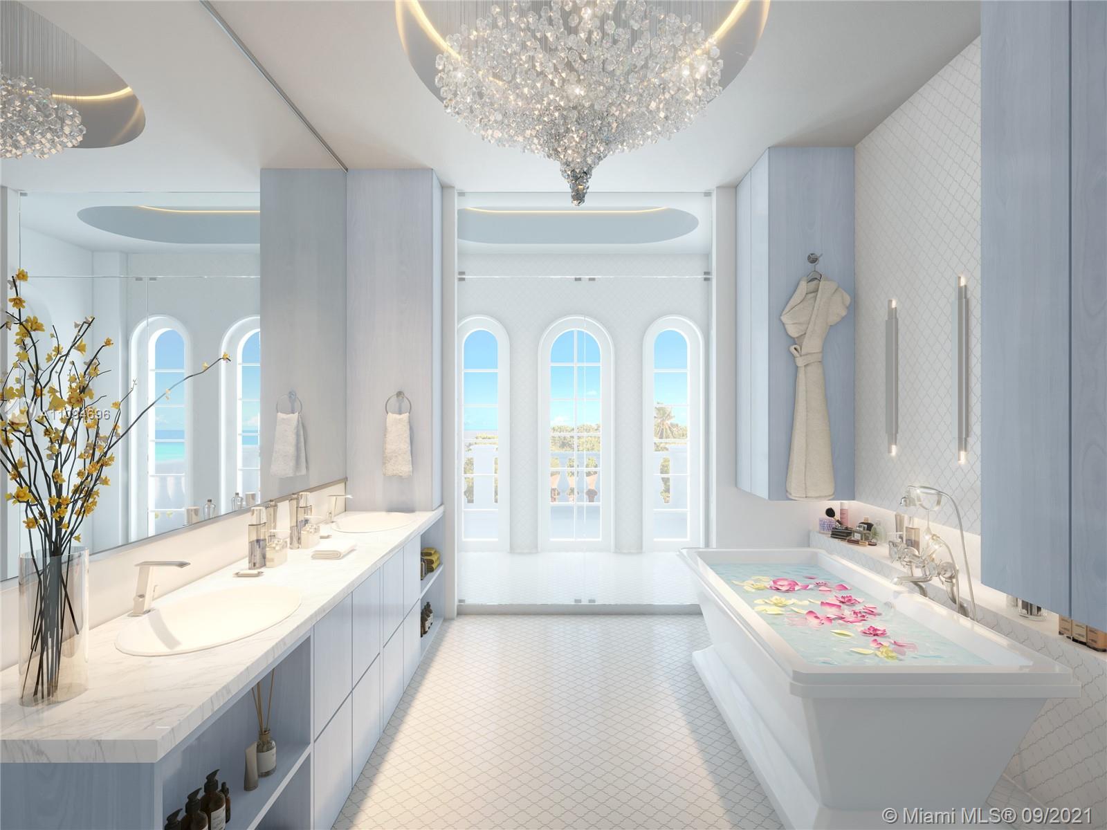 5465 Pine Tree Drive Miami Beach, FL 33140 - Photo 11 of 18 a spacious bathroom with a bathtub sink and mirror