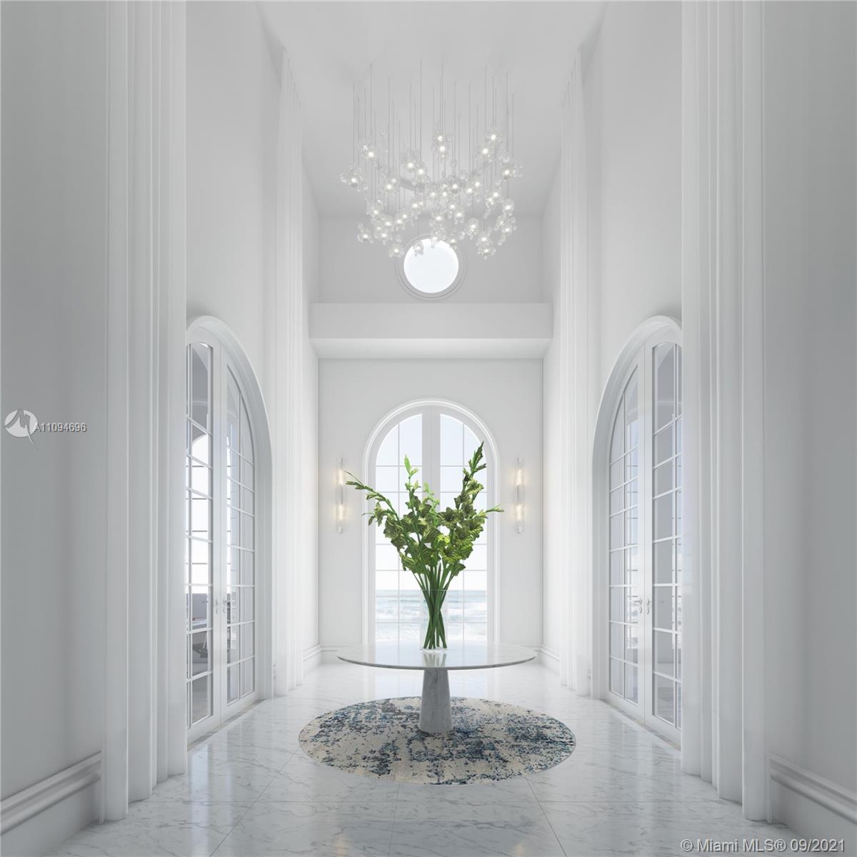 5465 Pine Tree Drive Miami Beach, FL 33140 - Photo 6 of 18 a view of a chandelier in a livingroom with a potted plant