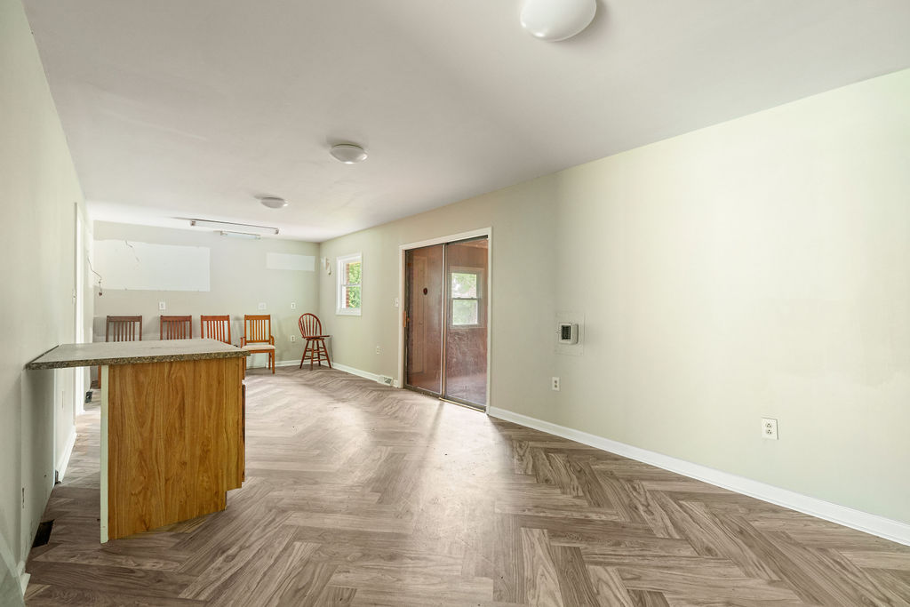 712 Whitney Way Anderson, SC 29625 - Photo 14 of 31 Herringbone pattern flooring defines this open-concept room, offering versatile living space.