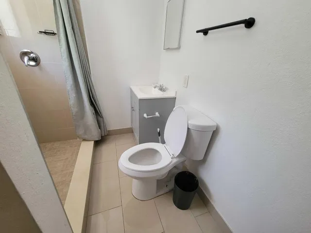 a toilet sitting in a bathroom next to a sink