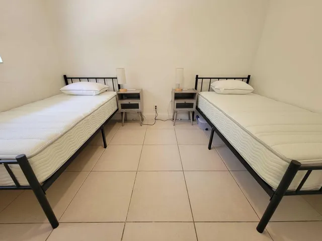 a room with two bed and a table