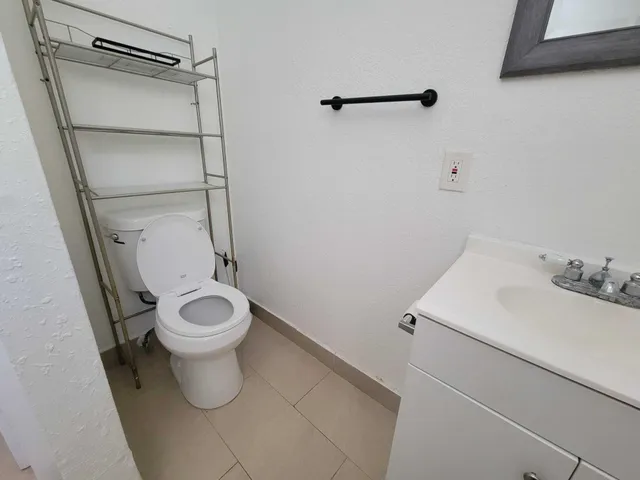 a white toilet sitting next to a bathroom sink