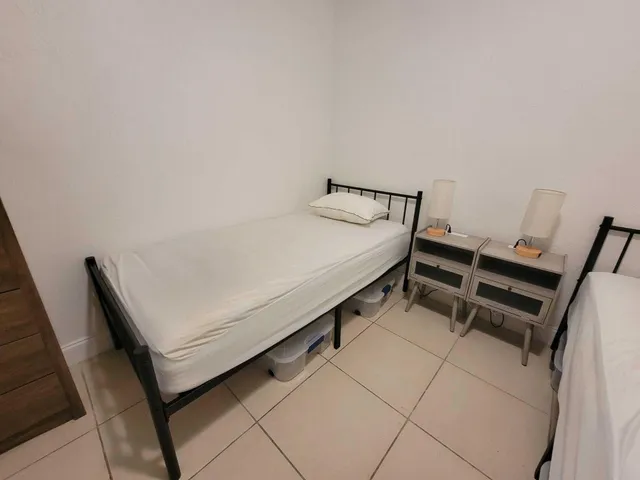 a bedroom with a bed and cabinets