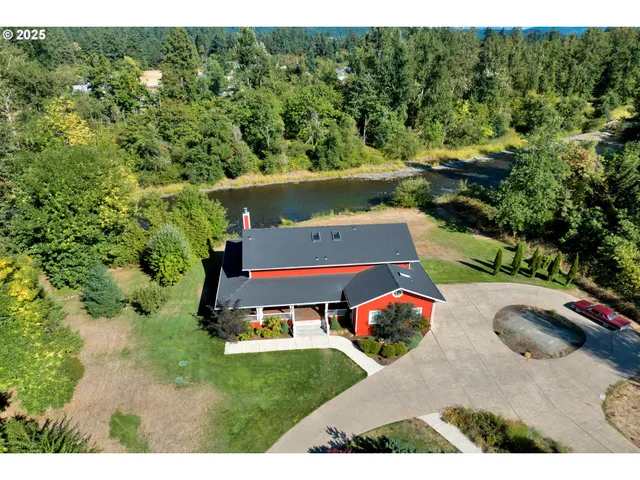 a view of a house with pool and a yard