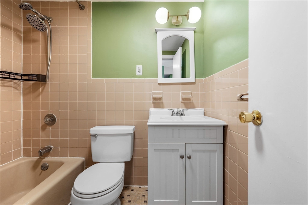 116 Sycamore Street, Unit 22 Somerville, MA 02145 - Photo 11 of 18 a bathroom with a sink mirror toilet and bathtub
