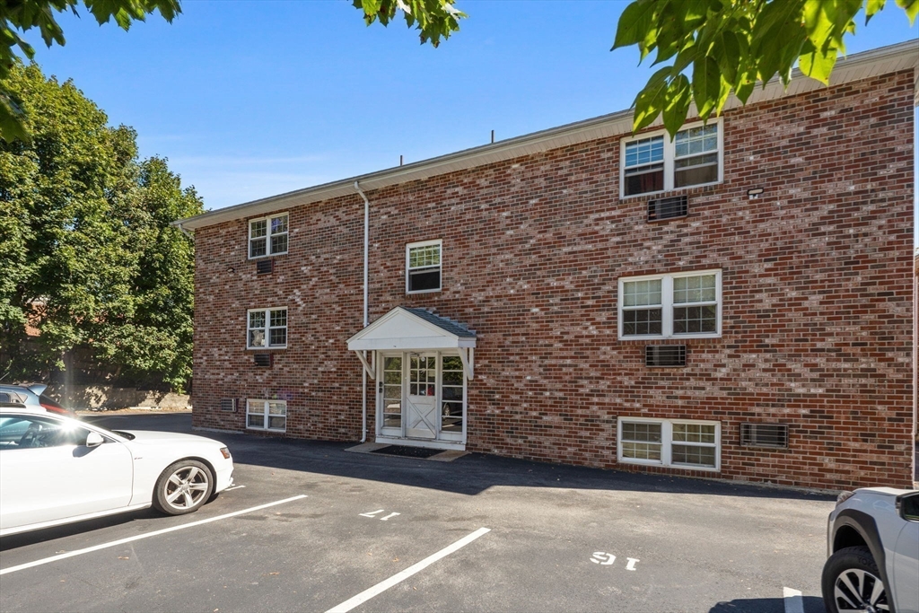 116 Sycamore Street, Unit 22 Somerville, MA 02145 - Photo 14 of 18 a front view of a house with parking space