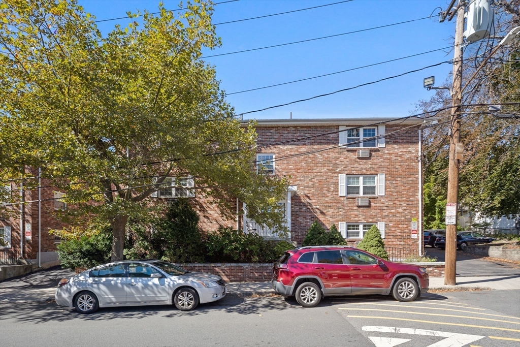 116 Sycamore Street, Unit 22 Somerville, MA 02145 - Photo 15 of 18 a car parked in front of a building