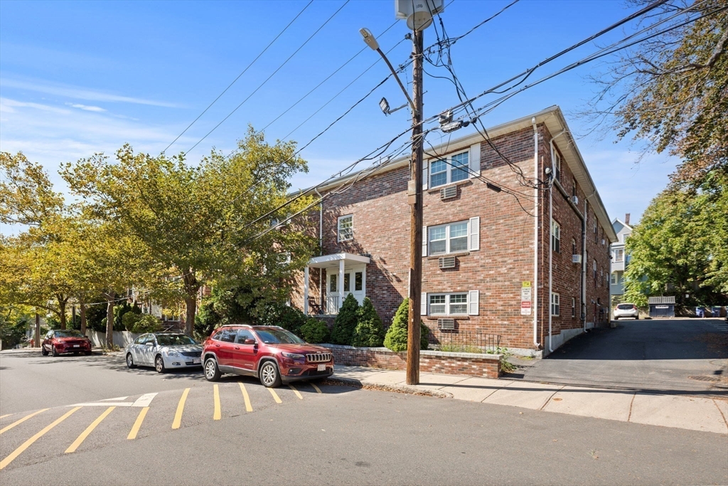 116 Sycamore Street, Unit 22 Somerville, MA 02145 - Photo 16 of 18 a couple of cars parked in front of a house
