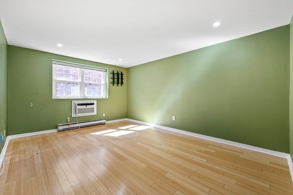 116 Sycamore Street, Unit 22 Somerville, MA 02145 - Photo 2 of 18 a view of an empty room with a window