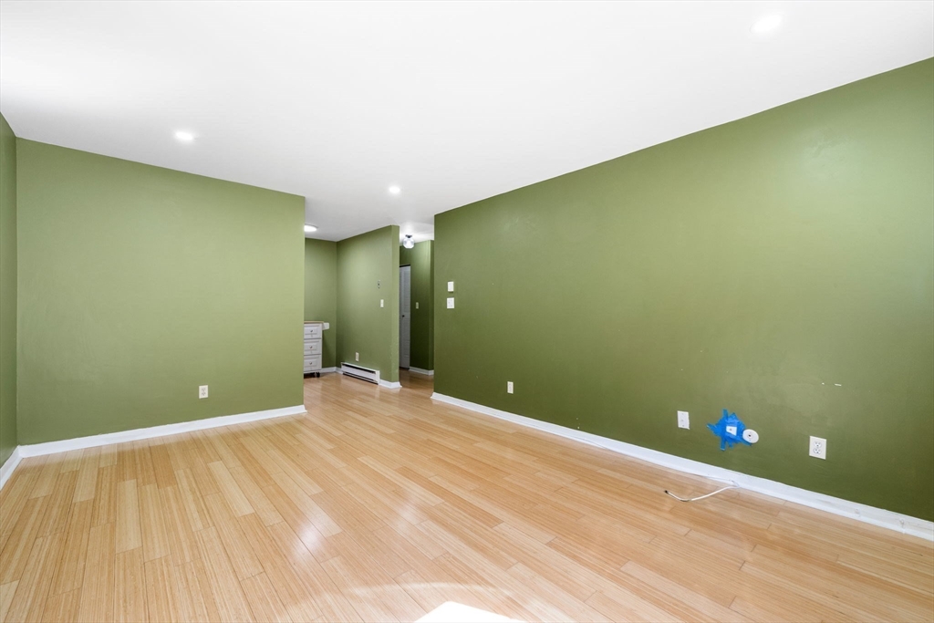 116 Sycamore Street, Unit 22 Somerville, MA 02145 - Photo 3 of 18 a view of an empty room with wooden floor