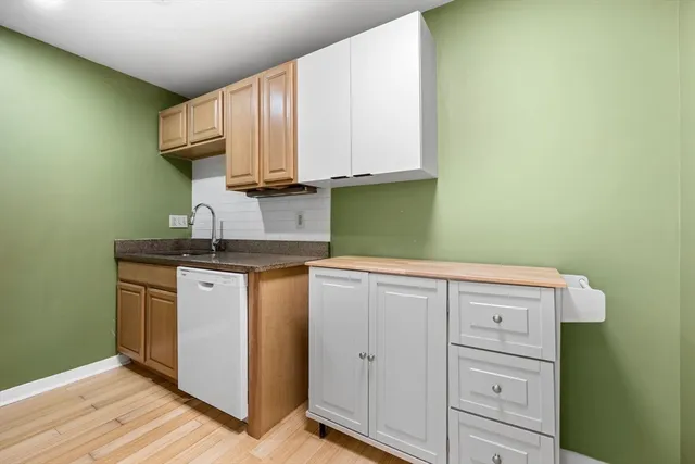 a kitchen with a refrigerator and a sink