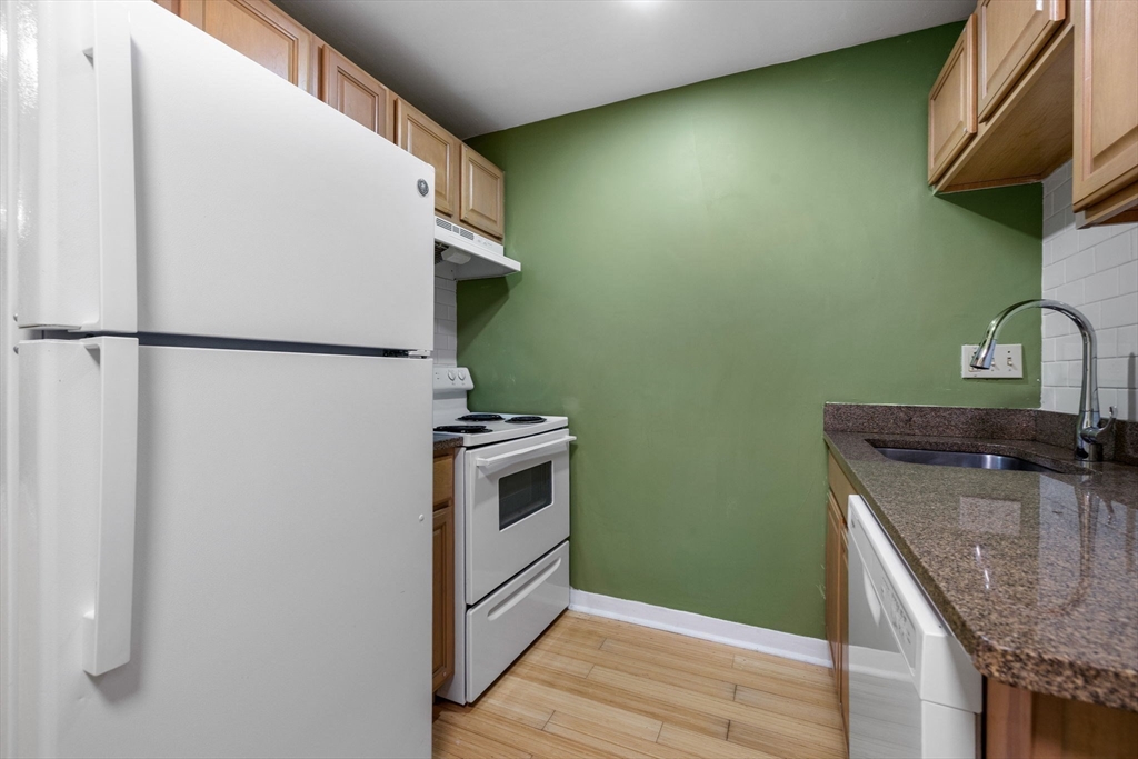 116 Sycamore Street, Unit 22 Somerville, MA 02145 - Photo 8 of 18 a kitchen with a refrigerator and a sink