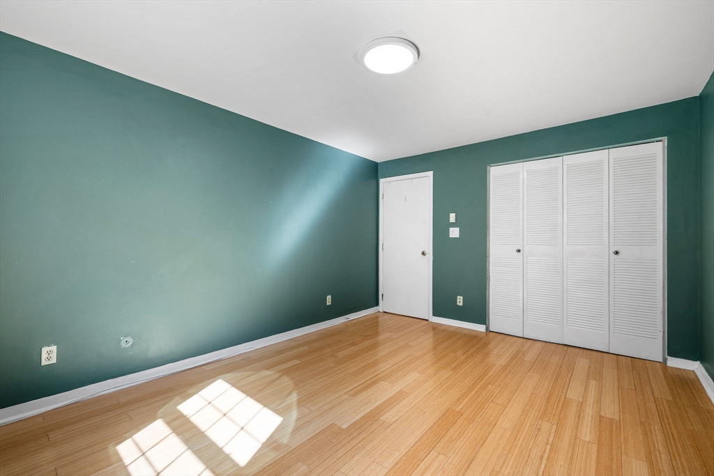 116 Sycamore Street, Unit 22 Somerville, MA 02145 - Photo 10 of 18 a view of a big room with wooden floor and windows