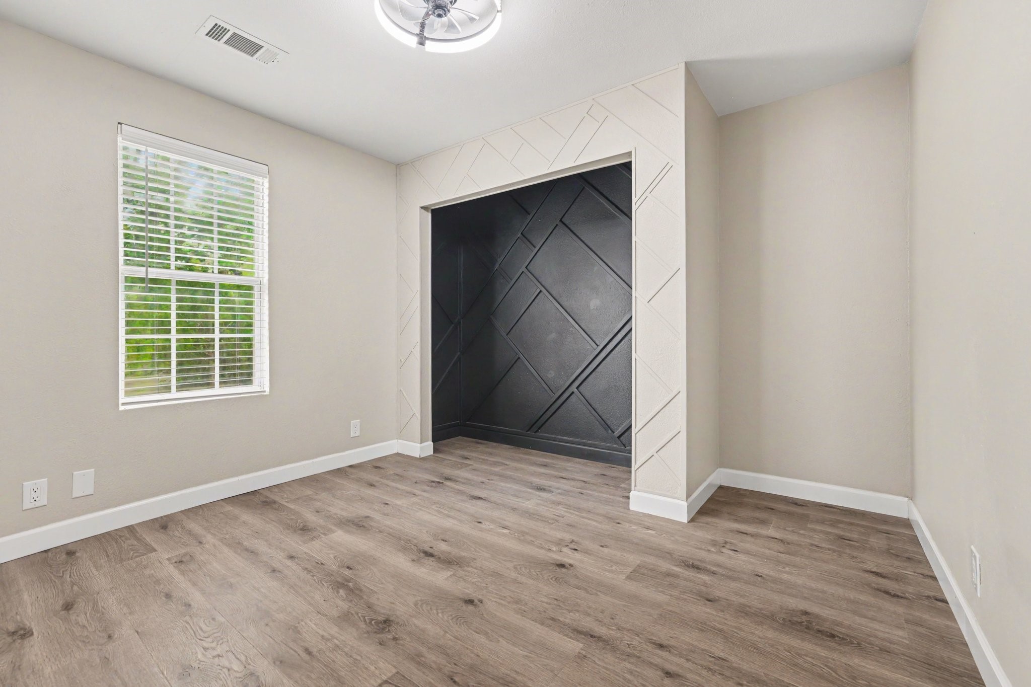 31730 Waller Tomball Road Waller, TX 77484 - Photo 38 of 50 A large window in the bedroom allows natural light to brighten the space, creating a cozy and stylish atmosphere.