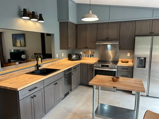 a kitchen with a sink stainless steel appliances and cabinets