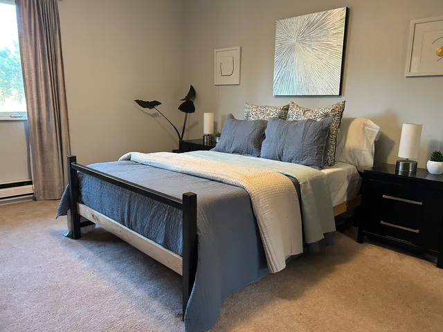 a bedroom with bed and window