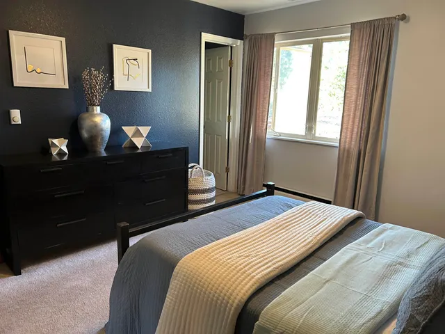 a bedroom with a bed and a window