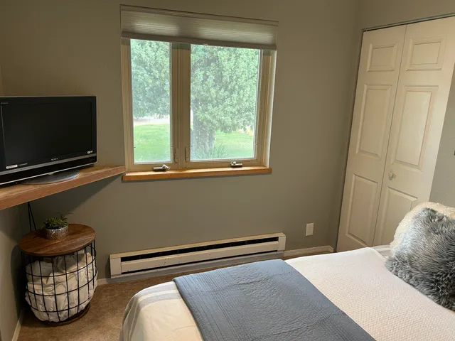 a bedroom with a bed and a television