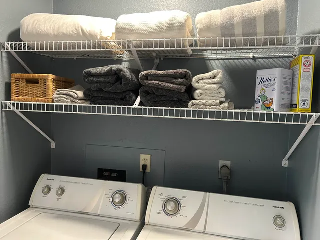 a living room with lots of furniture and clutter