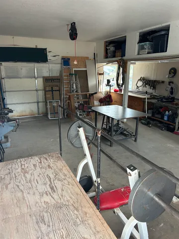 a living room with furniture a fireplace and a large window