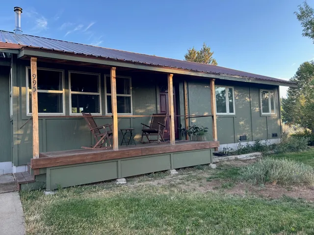 a view of a house with a small yard and plants
