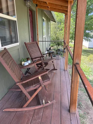 a view of balcony with wooden floor and outdoor seating