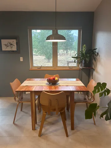 a view of a dining room with furniture window and outside view
