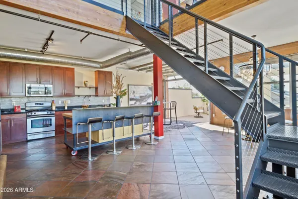 a view of kitchen with furniture and staircase