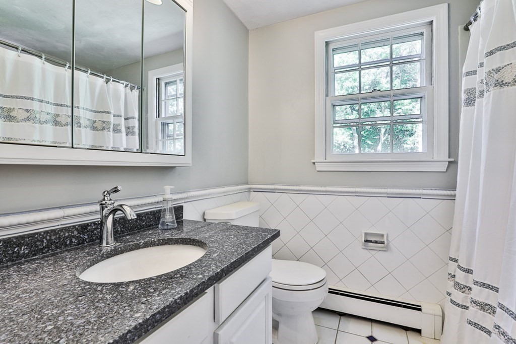 22 Withington Lane Harvard, MA 01451 - Photo 15 of 26 a bathroom with a granite countertop sink and a mirror