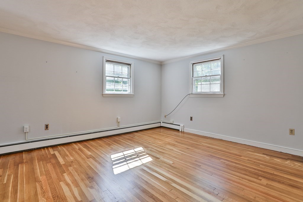 22 Withington Lane Harvard, MA 01451 - Photo 18 of 26 an empty room with wooden floor and windows