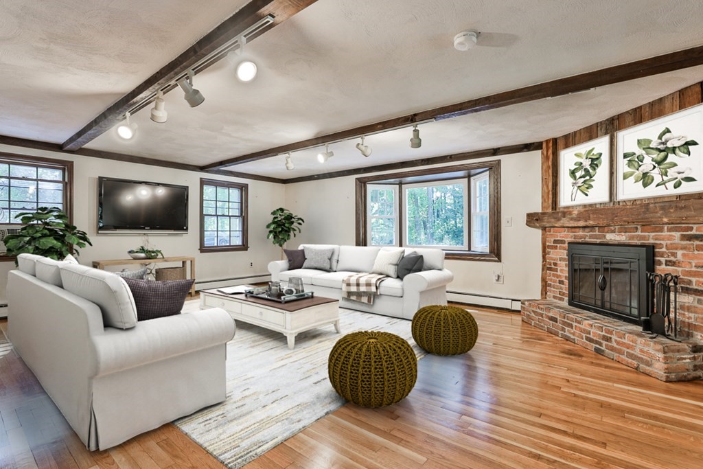 22 Withington Lane Harvard, MA 01451 - Photo 4 of 26 a living room with furniture a fireplace and a flat screen tv