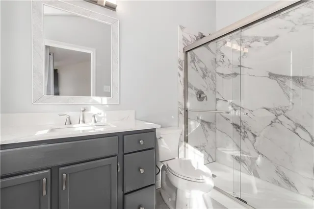 a bathroom with a sink toilet and shower