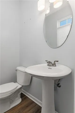 a bathroom with a sink mirror and toilet