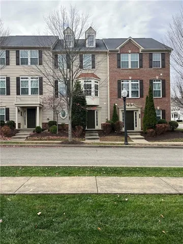 a front view of a residential apartment building with a yard