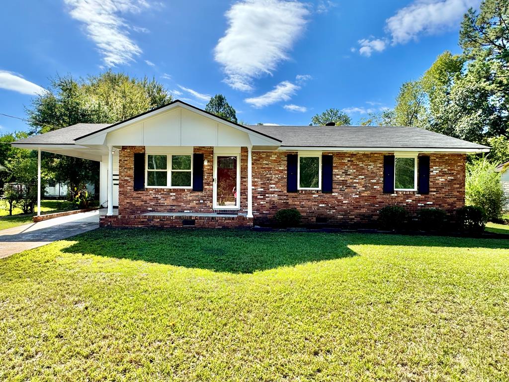 a front view of house with yard and outdoor seating