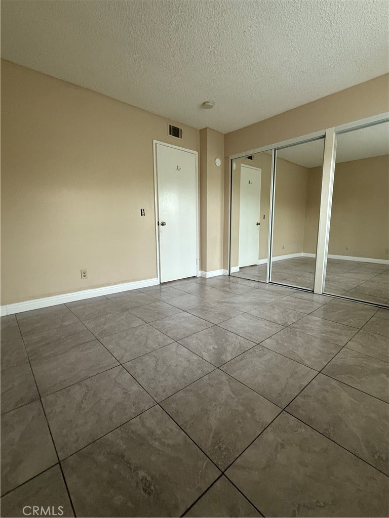 1735 East Washington Street, Unit G13 Colton, CA 92324 - Photo 3 of 19 a view of an empty room and window