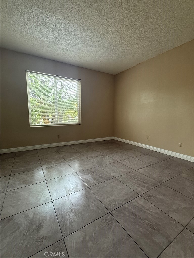 1735 East Washington Street, Unit G13 Colton, CA 92324 - Photo 7 of 19 a view of an empty room with a window