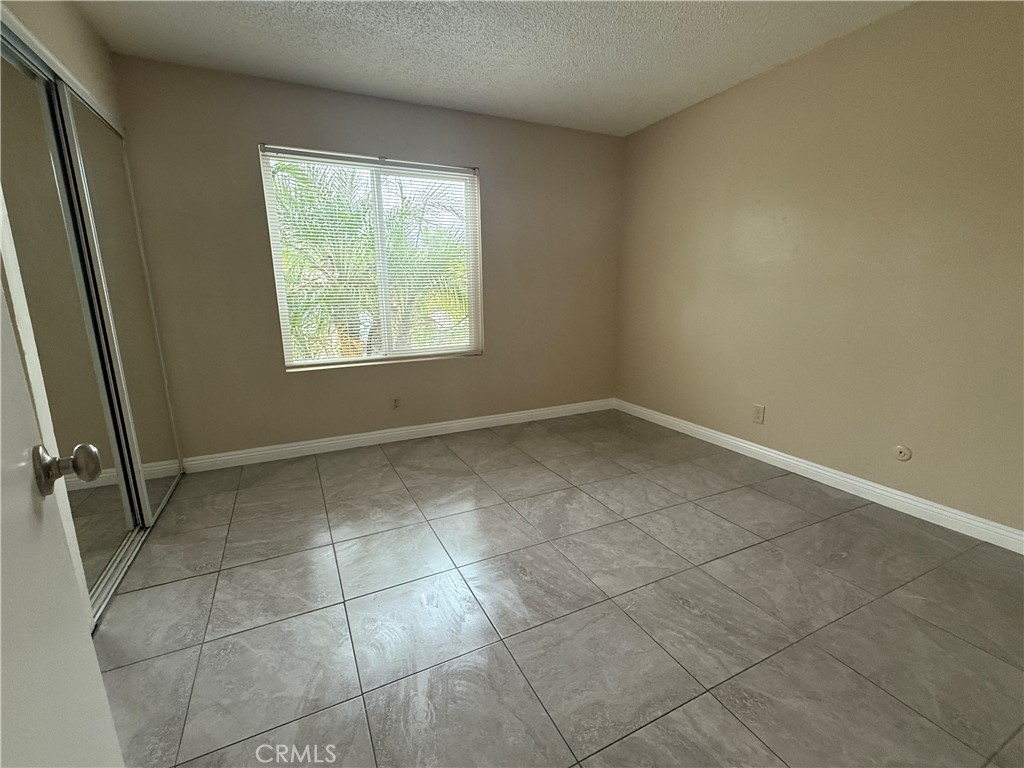 1735 East Washington Street, Unit G13 Colton, CA 92324 - Photo 8 of 19 an empty room with windows
