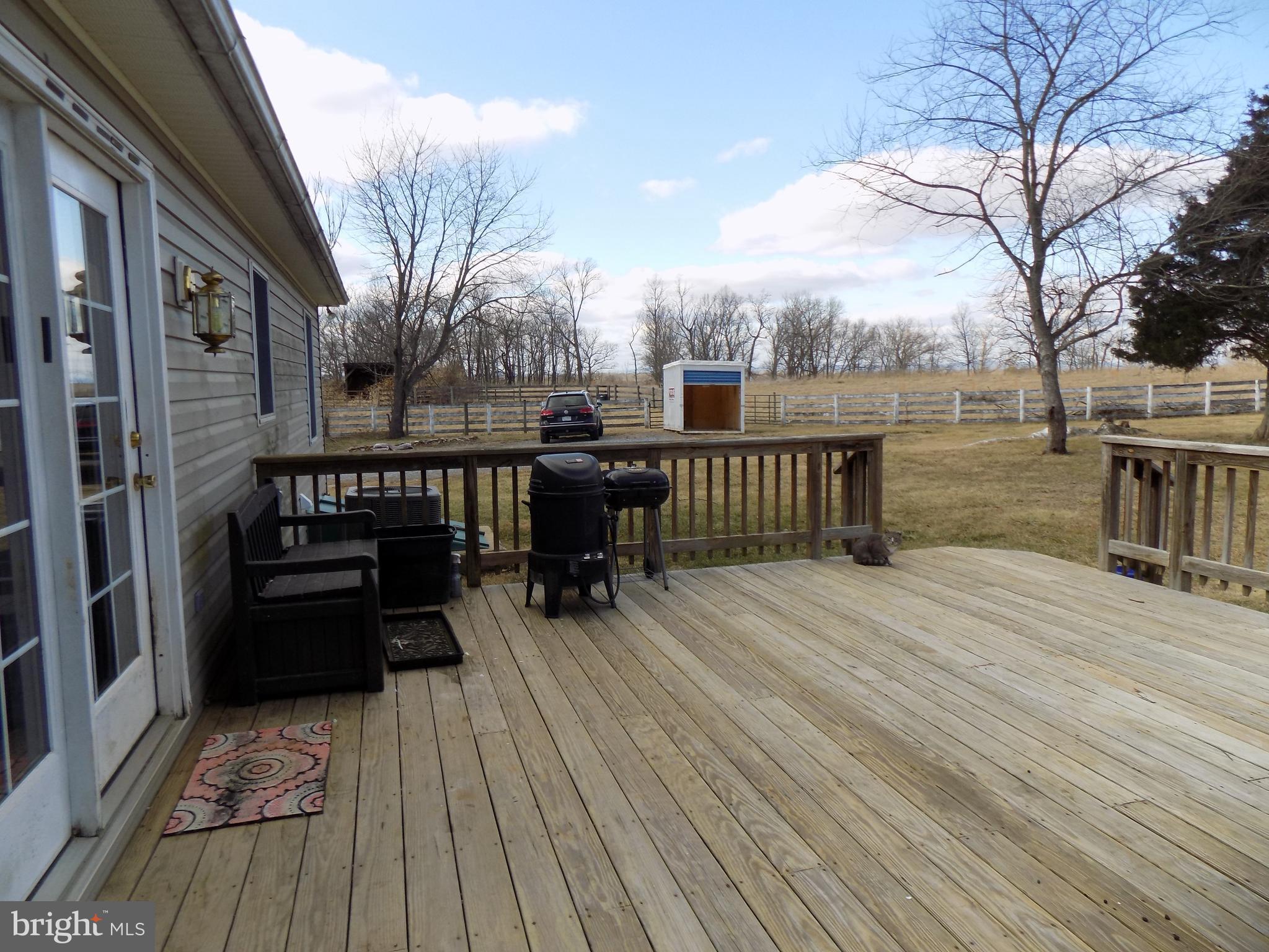 150 Longmarsh Road Berryville, VA 22611 - Photo 12 of 22 a view of a patio with table and chairs with wooden floor and fence