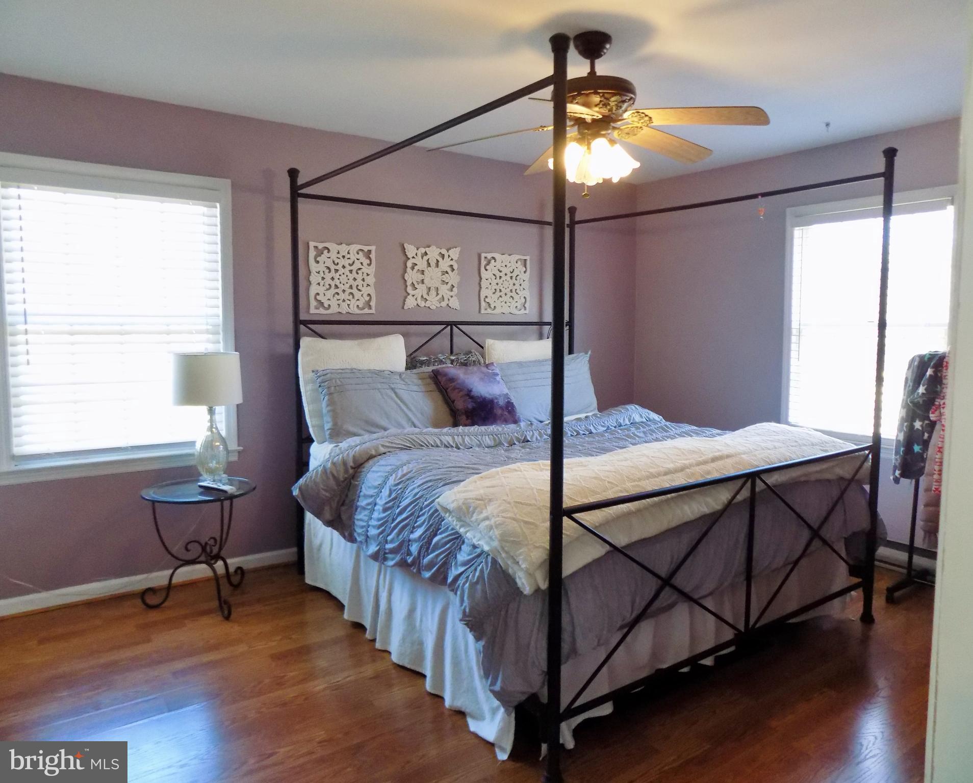 150 Longmarsh Road Berryville, VA 22611 - Photo 18 of 22 a bedroom with a bed a chandelier and a window