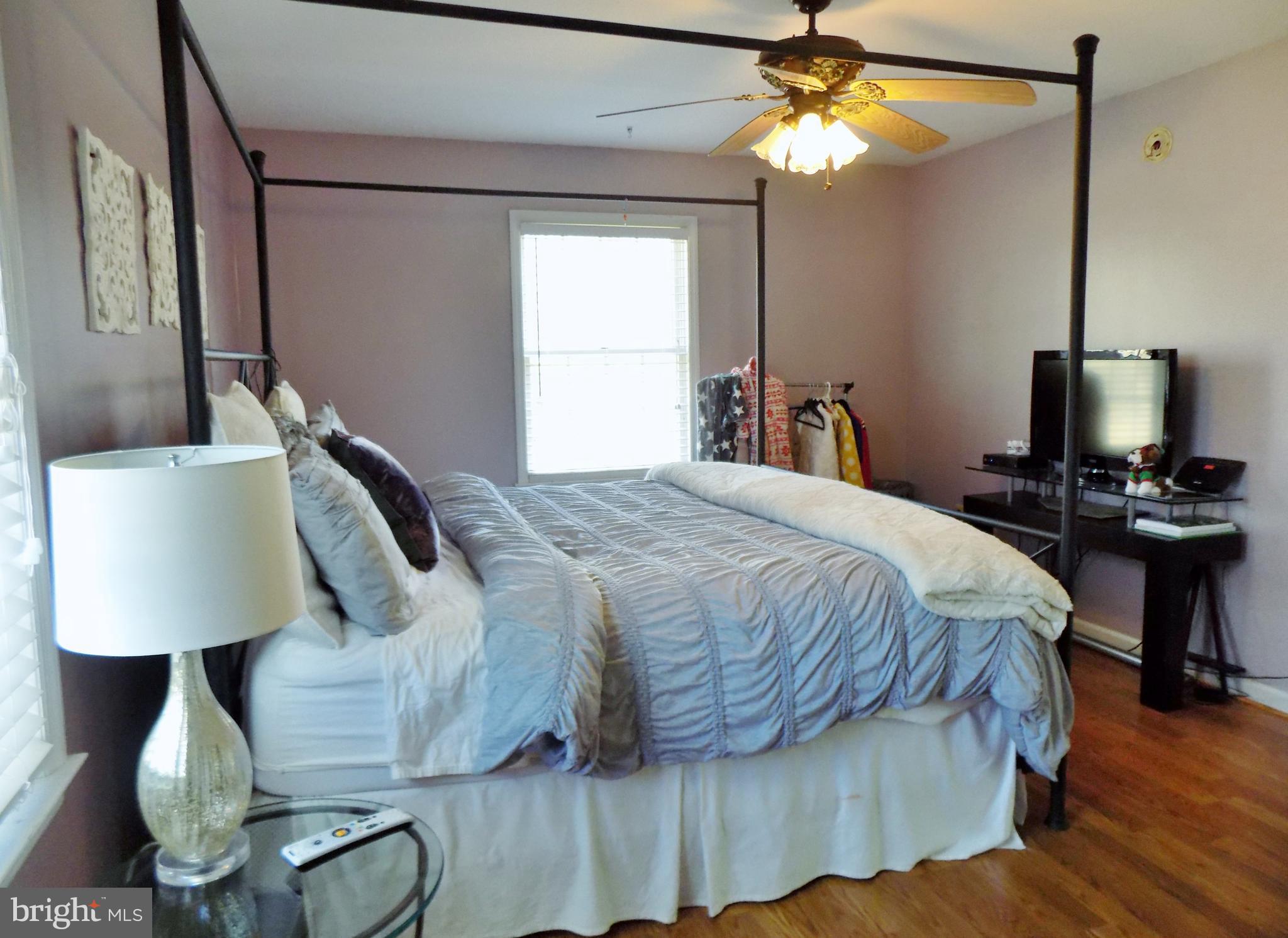 150 Longmarsh Road Berryville, VA 22611 - Photo 19 of 22 a bedroom with a bed and a lamp