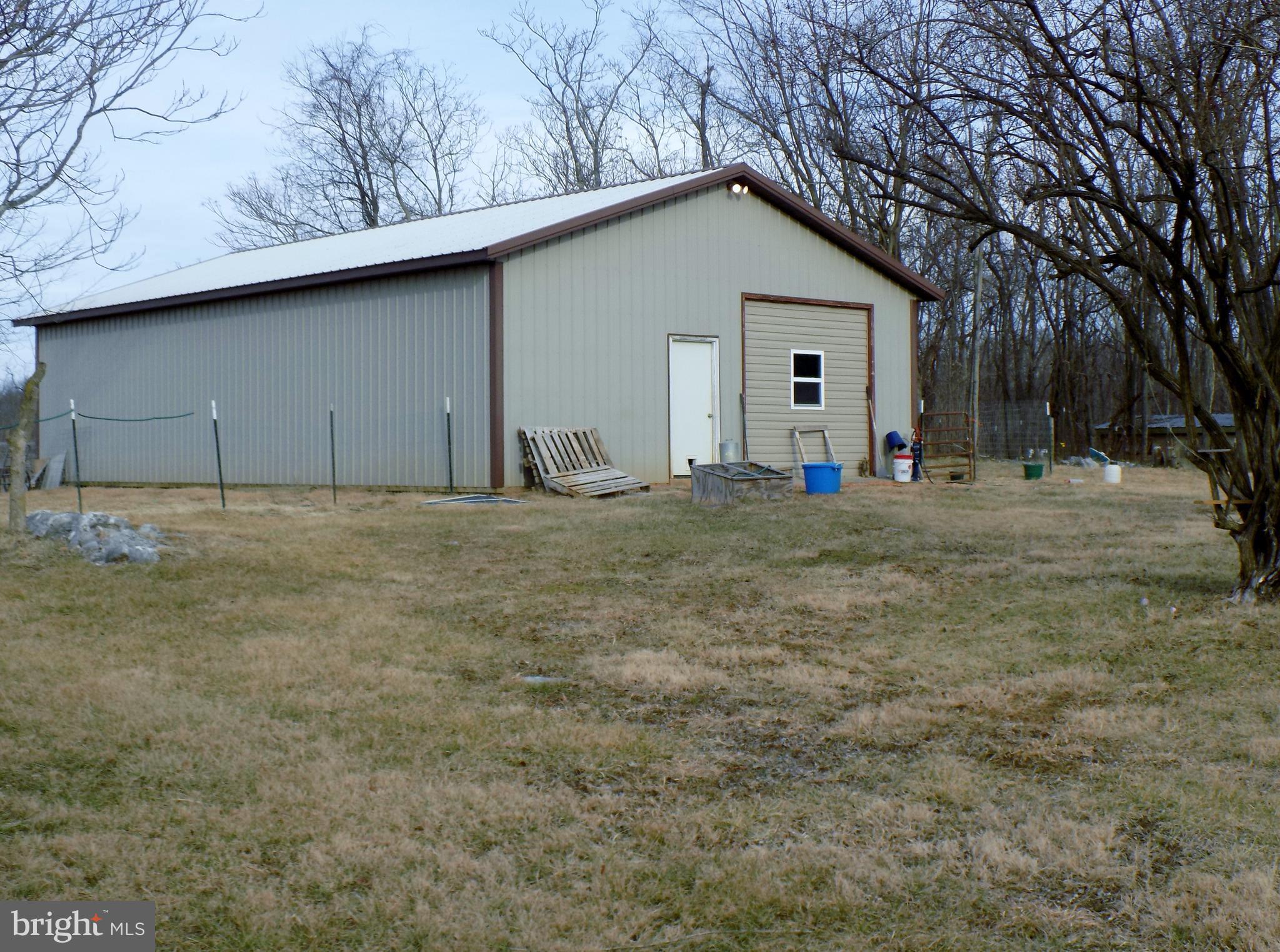150 Longmarsh Road Berryville, VA 22611 - Photo 3 of 22 a big house with trees in the background
