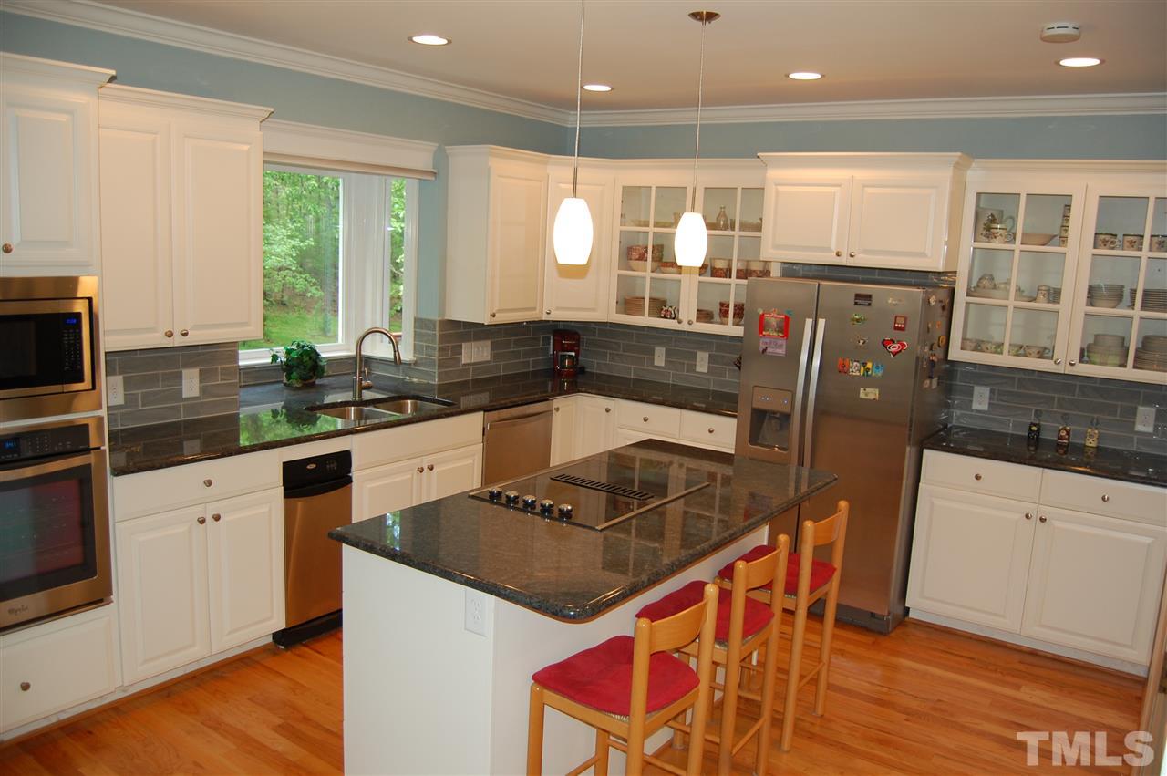 10425 Roadstead Way West Raleigh, NC 27613 - Photo 8 of 25 a kitchen with stainless steel appliances granite countertop a sink stove and cabinets