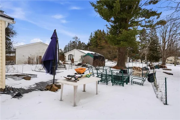 a view of a patio with a table and chairs