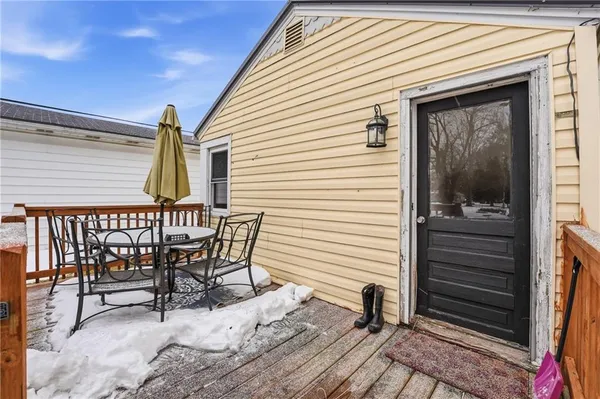a view of wooden house with a yard